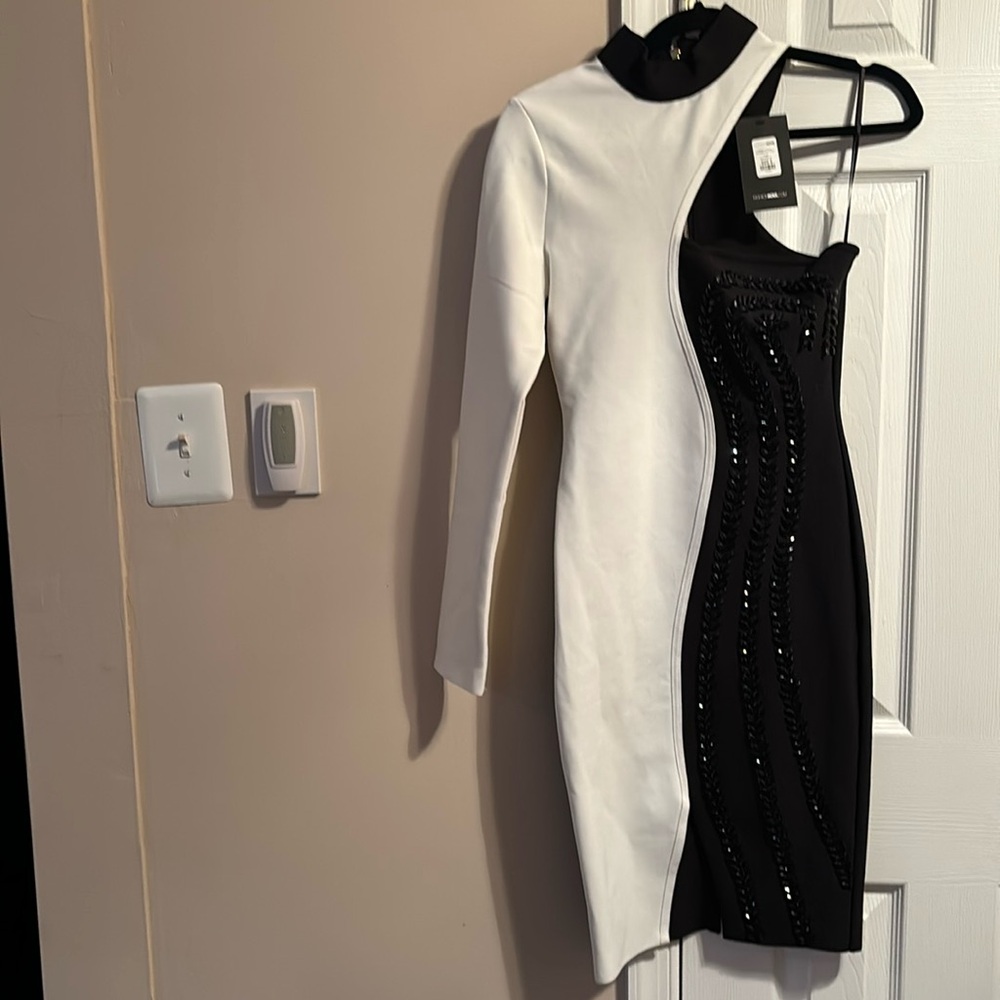 Black and white one shoulder dress with black beading down the dress
